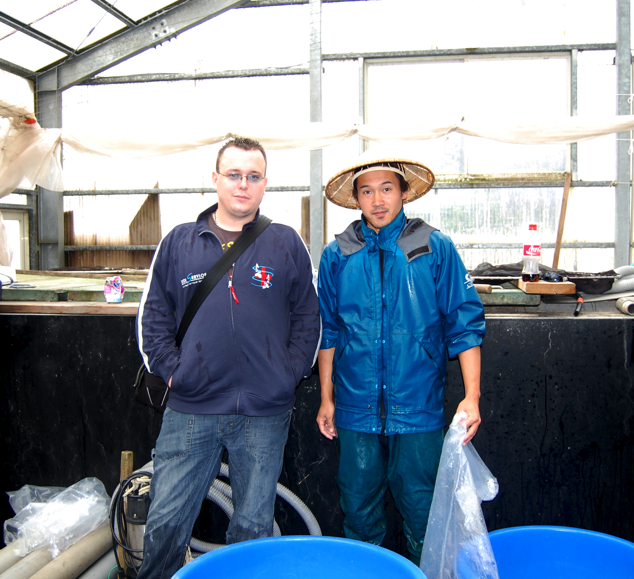 Takashi Kawakami standing with staff from Perfect Ponds and Koi